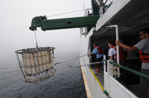 mMelissa Miller (left, Scripps Institution of Oceanography) and Crystal Breier (center, Woods Hole Oceanographic Institution) retrieve a CTD rosette to the deck of the R/V Ka'imikai-O-Kanaloa in June 2011. The team on the ship sampled water from the surface to as deep as 2000 meters at 30 locations in the Northwest Pacific ranging from 600 kilometers to 30 kilometers off the coast of Japan.